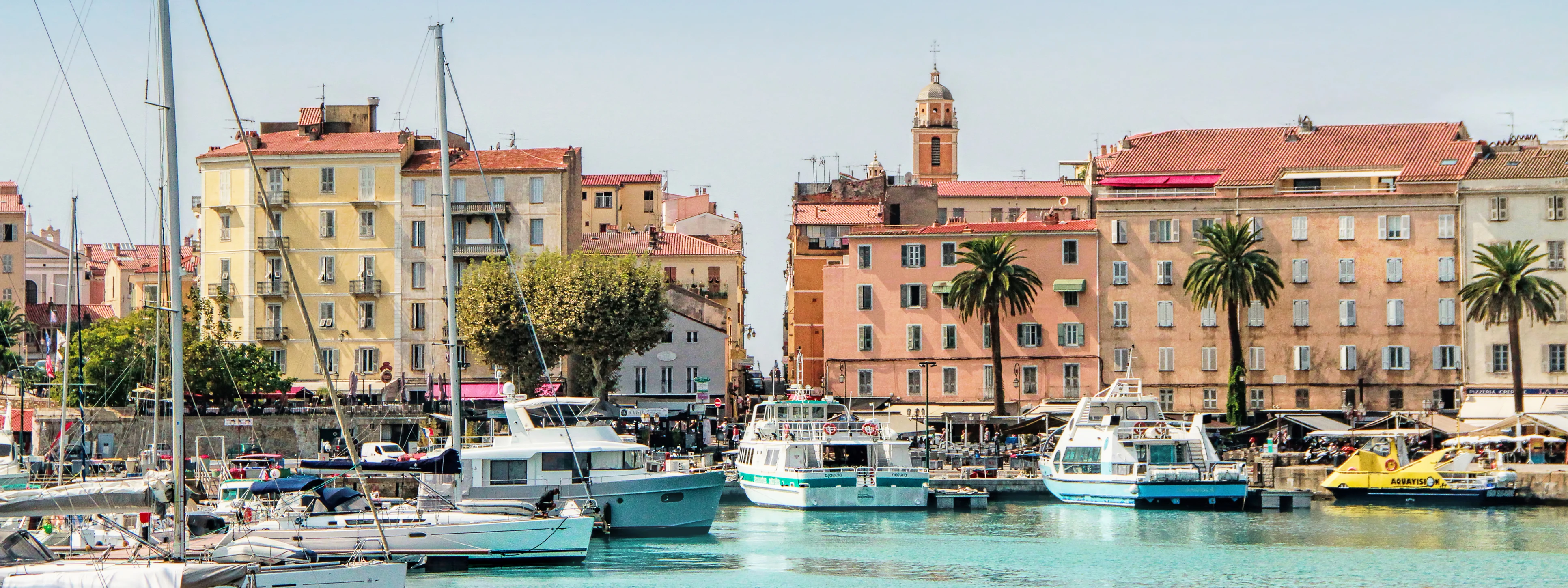 Port d’Ajaccio en Corse du Sud avec ses bateaux de plaisance et les façades colorées du centre historique, symbole du charme méditerranéen.