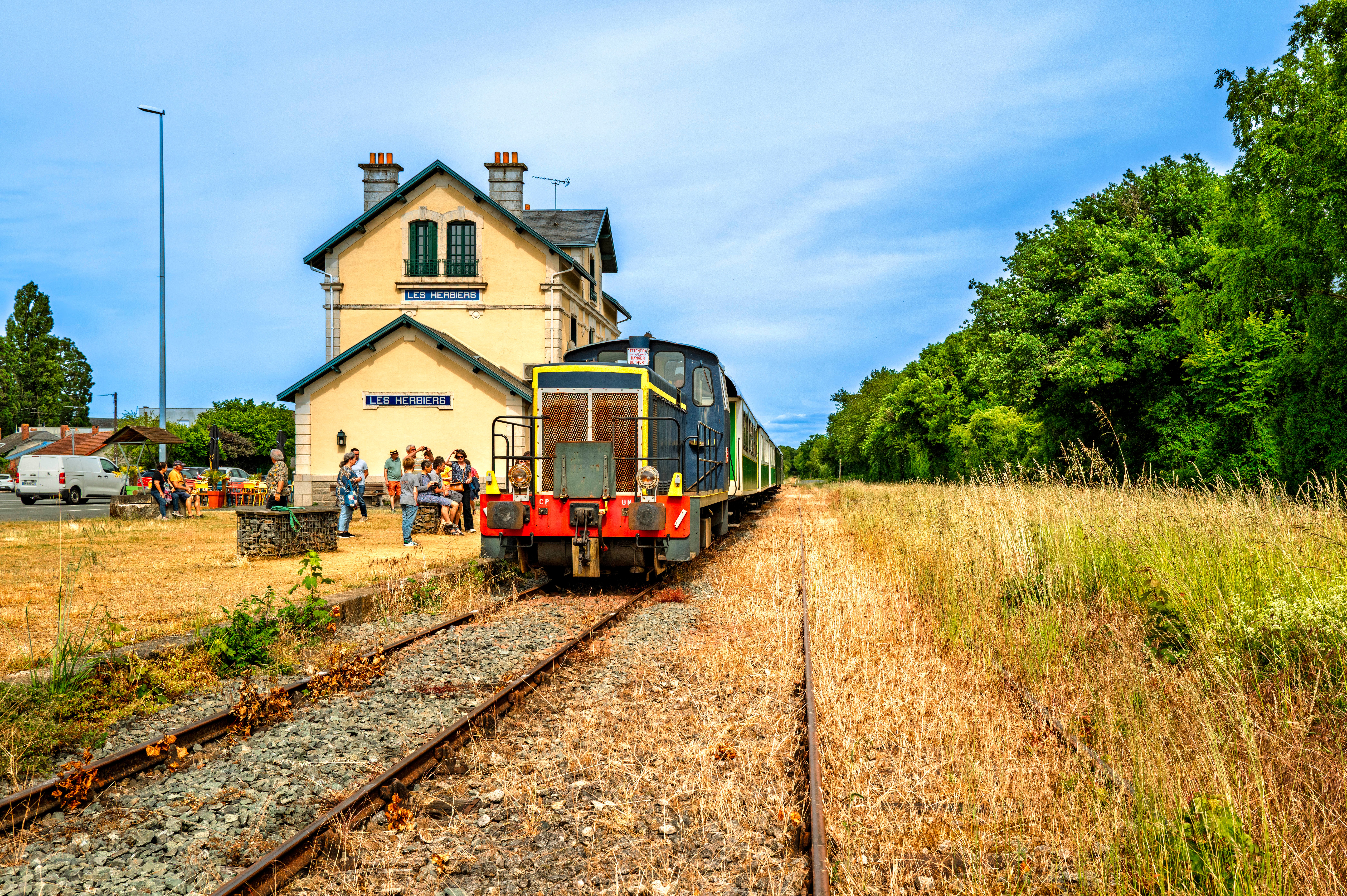 Train du chemin de fer de la Vendée arrivant en gare des Herbiers, dans une nature environnante