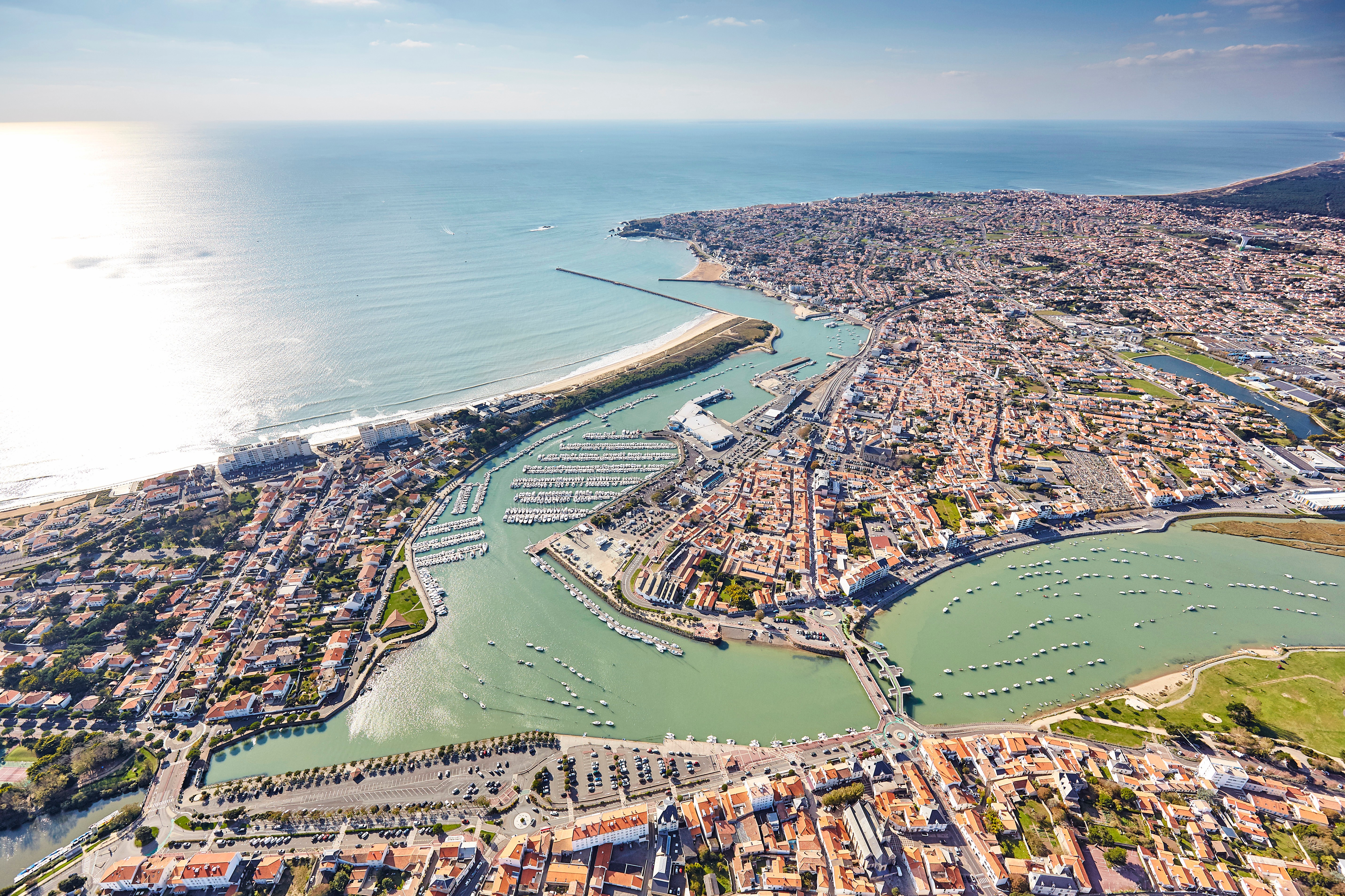 Vue du ciel de Saint Gilles Croix de vie avec le centre-ville, les habitations, son port de plaisance et de pêche ainsi que la grande plage.