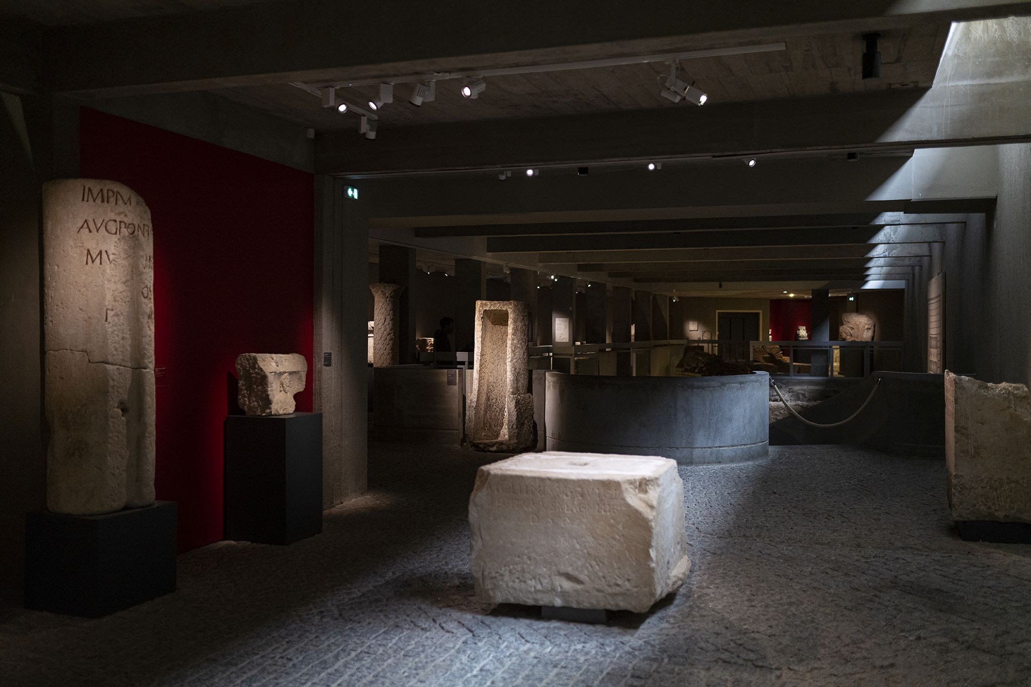 Une des salles du musée Sainte Croix dans la pénombre avec des vestiges gallo romains