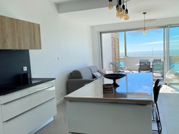 Kitchen opening onto living room
