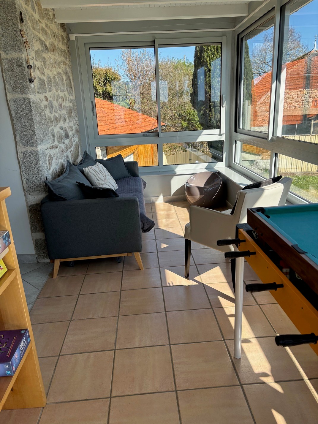 bright veranda relaxing area outside view Cantal gîte