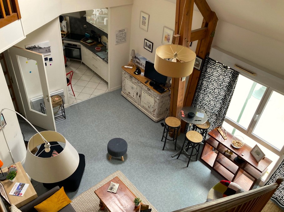Pièce de vie très agréable, haute de plafond et lumineuse avec salon et bureau. Cuisine ouverte.