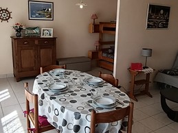 The dining area and sitting area in the living room. At the back on the left, the two bunk beds – “Le Beaulieu” flat