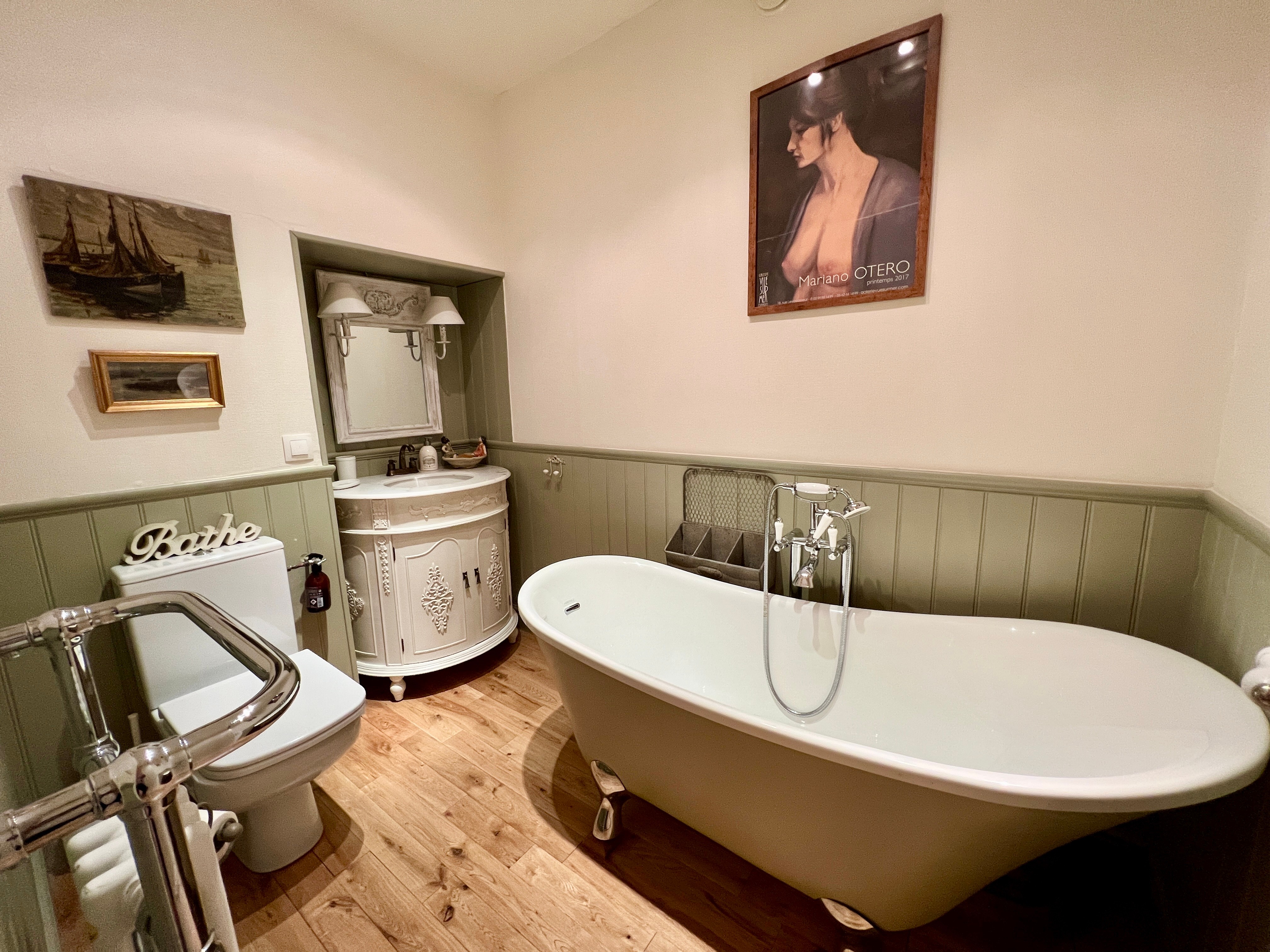 En-suite bathroom with bath and shower above bath, attached to the second floor bedroom