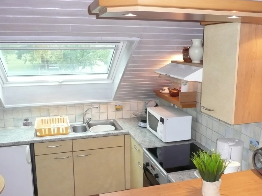 La cuisine toute équipée avec son coin bar