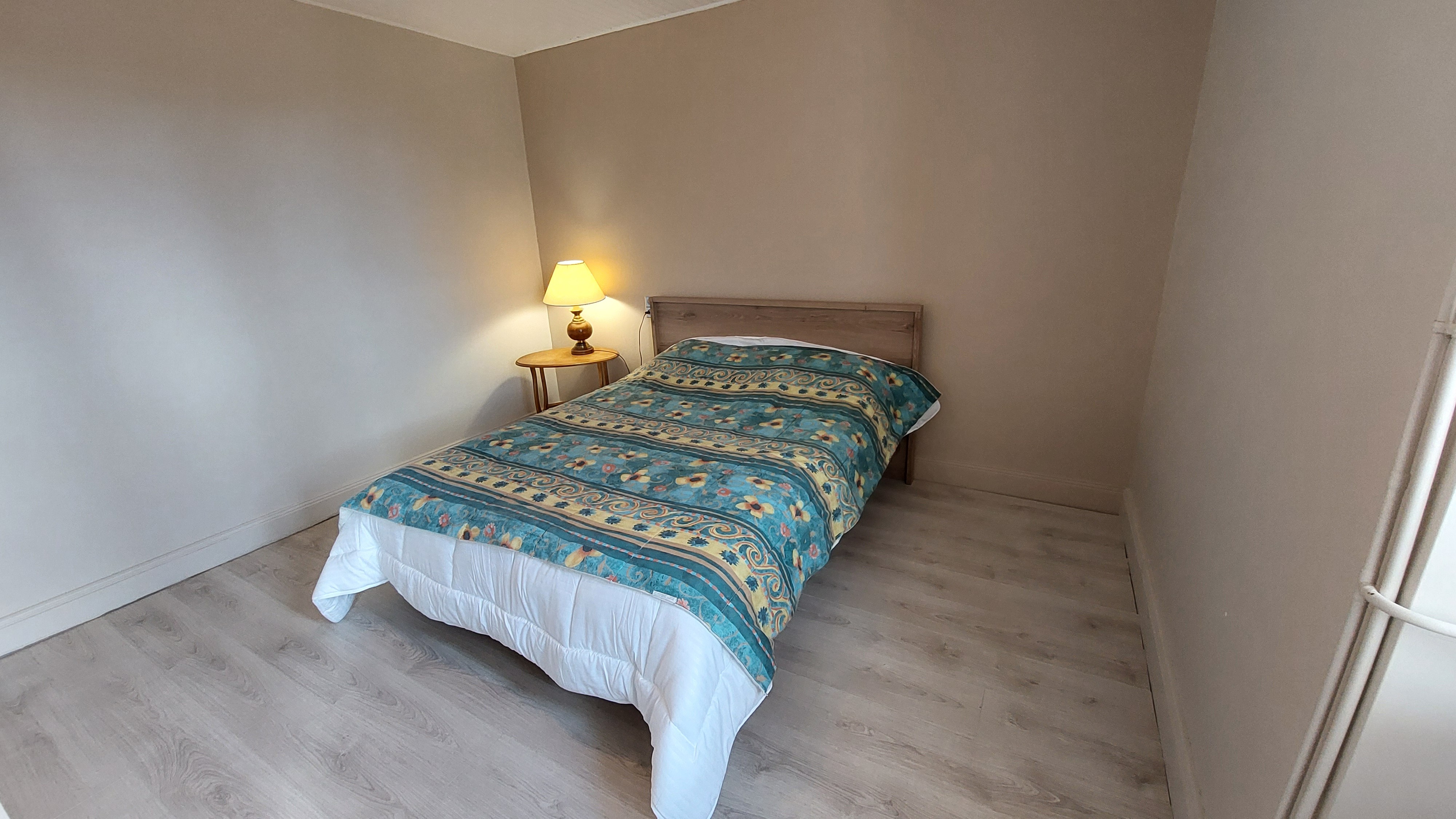 Room with double bed and simple decoration in holiday home Cantal