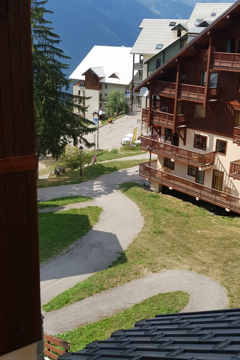 Depuis l'entrée de l'appartement B11, vue sur le chalet de réception ainsi que sur le départ de l'ESF (Ecole de Ski Française)