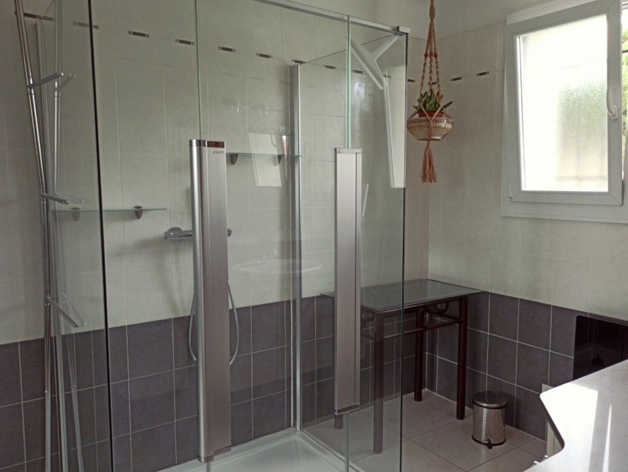 Salle de bain spacieuse avec grande cabine de douche