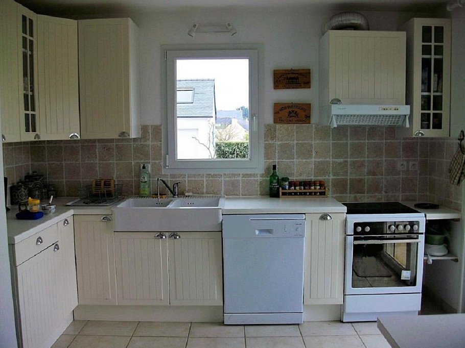 fitted kitchen with glass door to garden