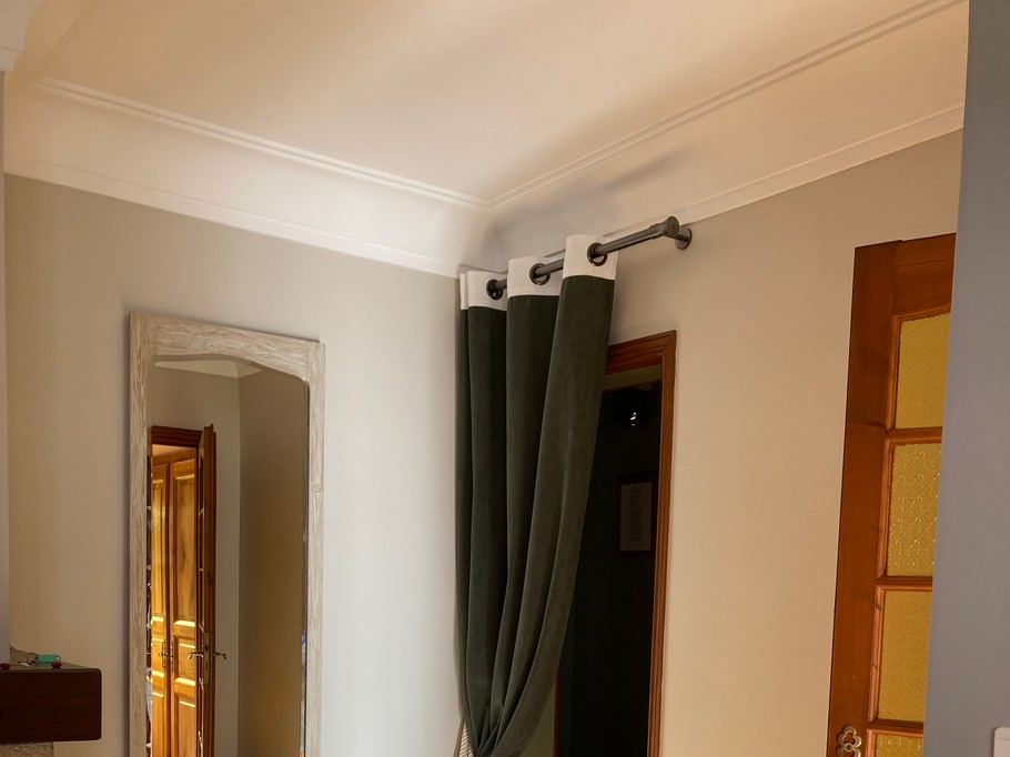 Entrance separating day and night living areas, with a large floor mirror