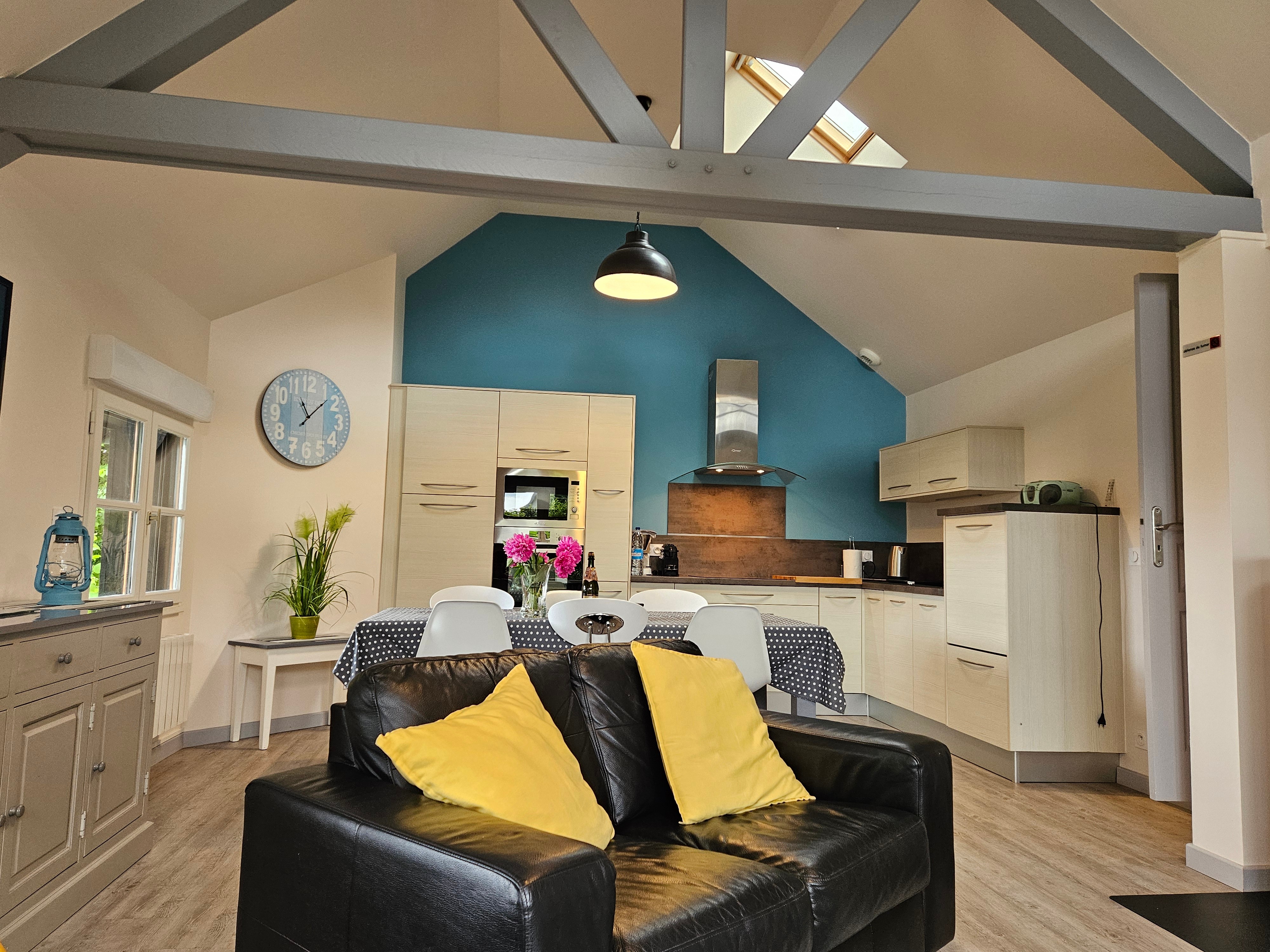 Living room with fitted kitchen, lounge and sitting area. Access to private terrace.