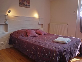 1st bedroom with 1 double bed and 2 bunk beds overlooking the courtyard