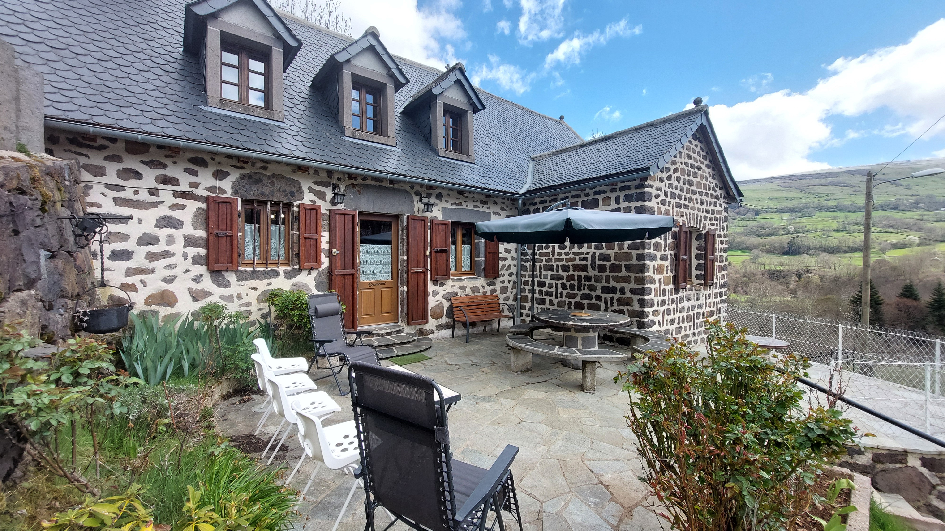 terrace with garden furniture stone house Cantal