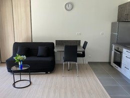 Dining area with fitted kitchen and sofa seat.