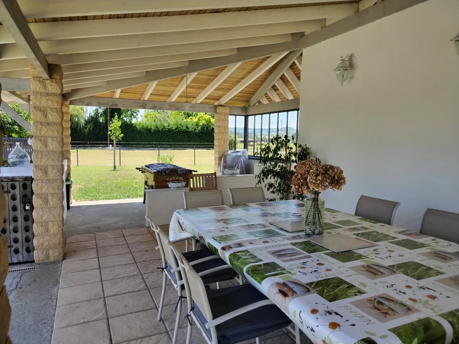 Terrasse couverte face à la piscine.