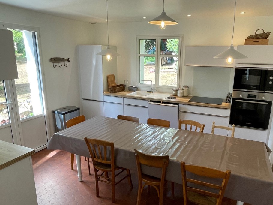Cuisine ouverte équipée avec grande table pour 12 personnes