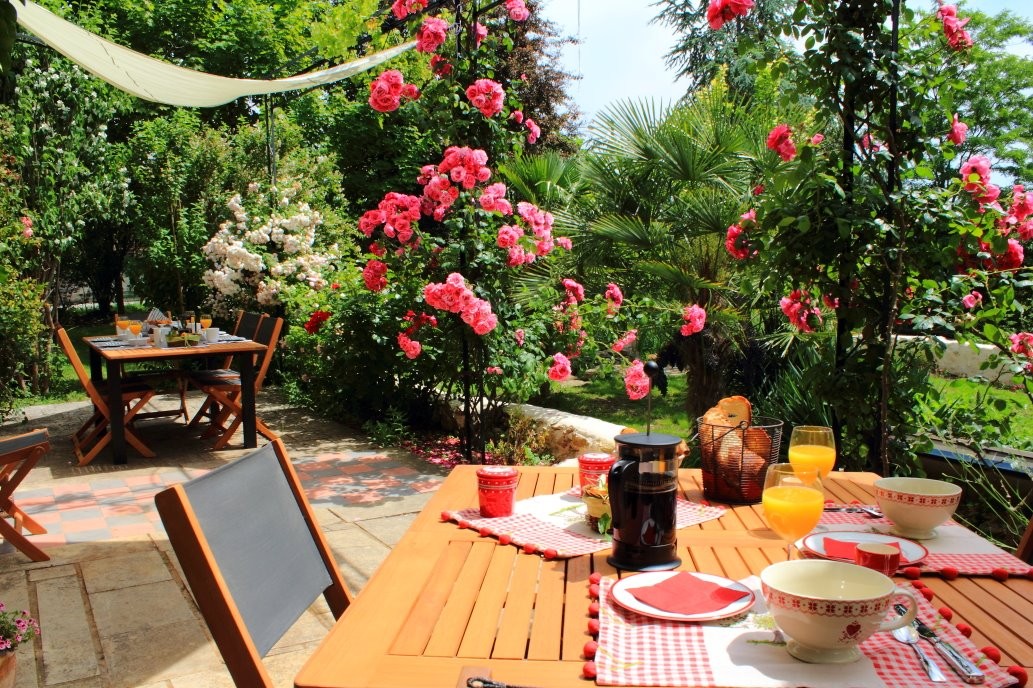 Petit déjeuner en terrasse face au jardin et aux vignes