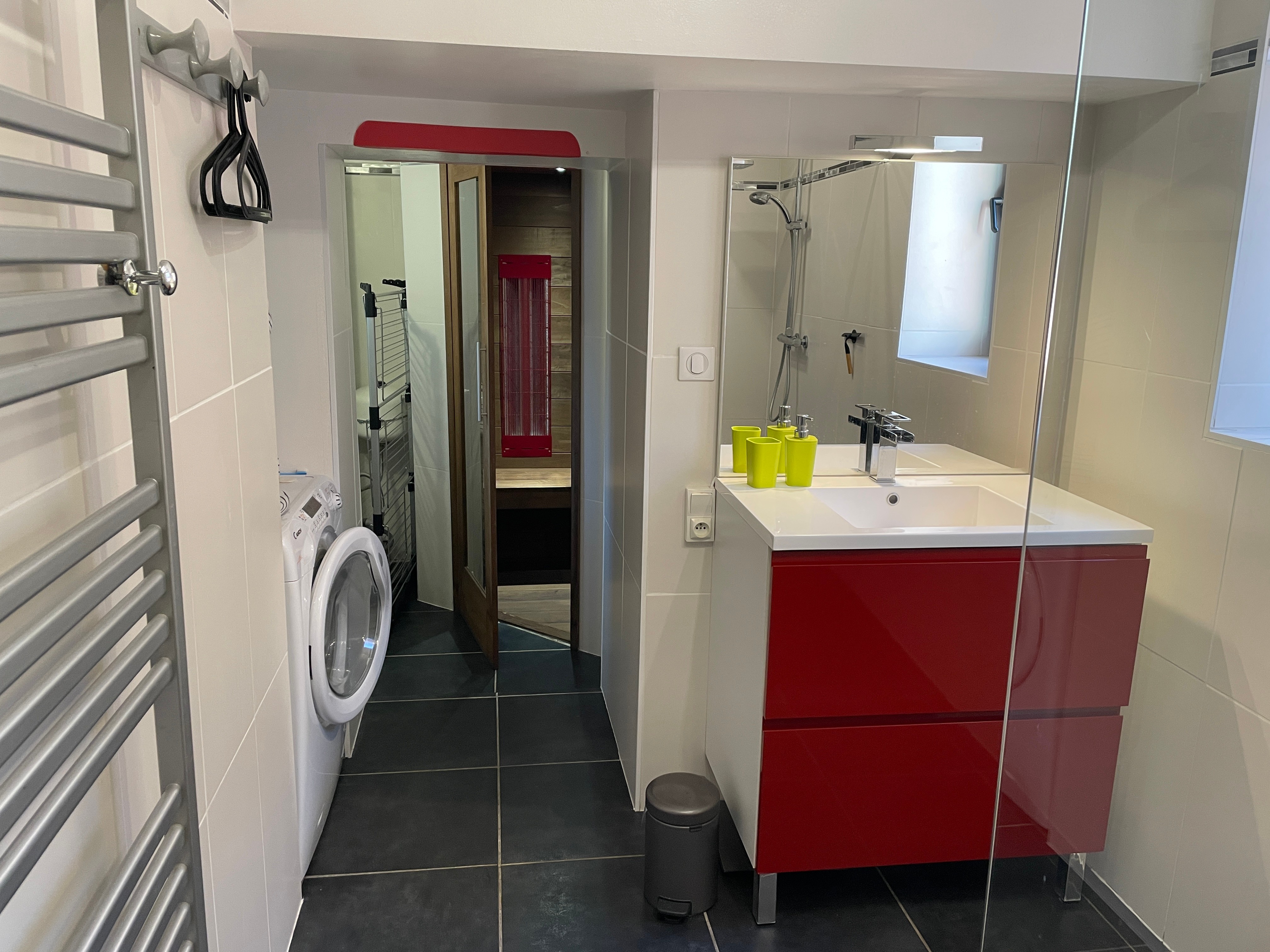 Spacious bathroom with walk-in shower, sauna, laundry area