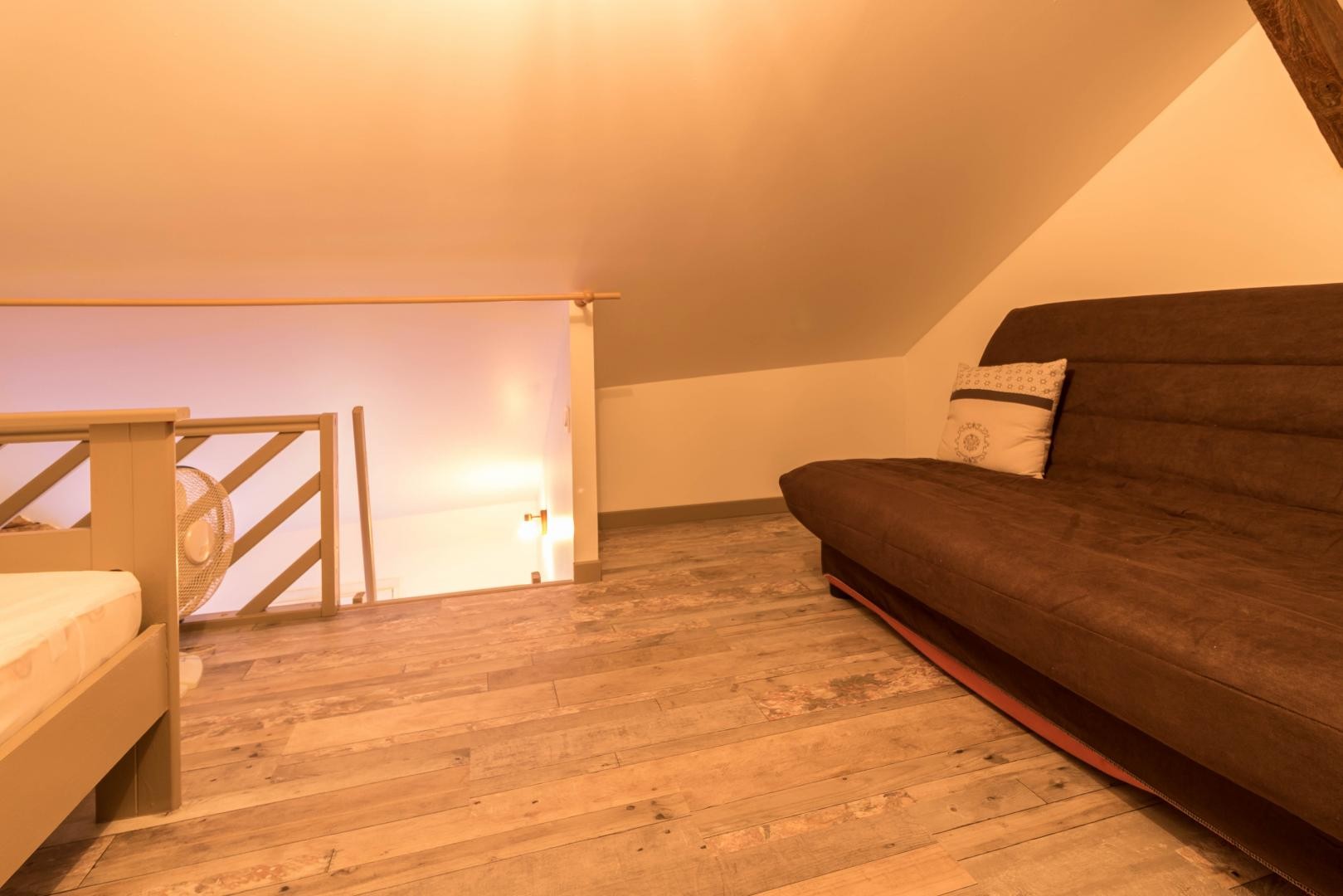 Sleeping and relaxation area on the mezzanine level, accessed via a steep staircase