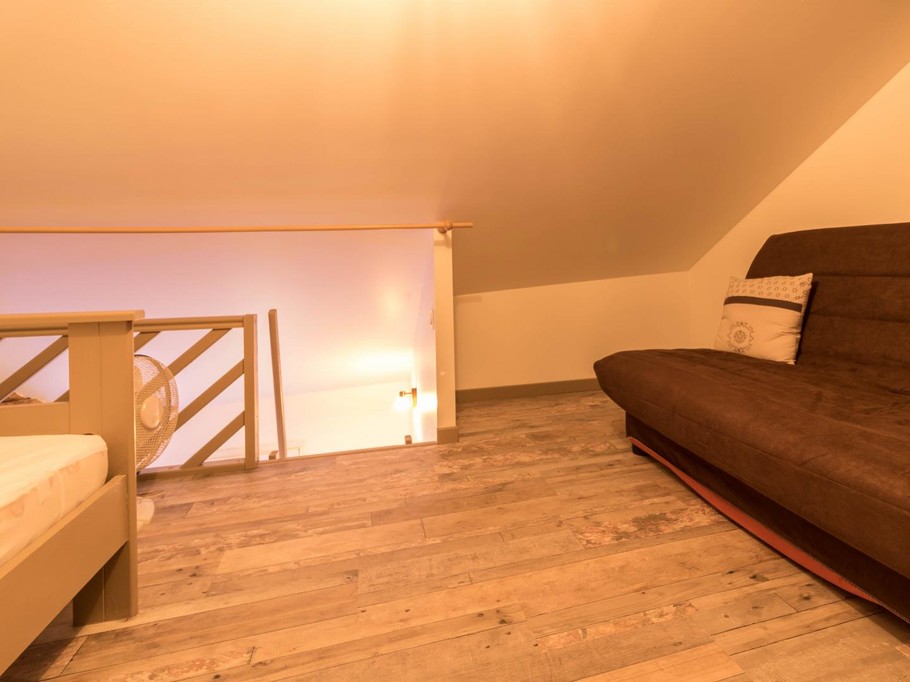 Sleeping and relaxation area on the mezzanine level, accessed via a steep staircase
