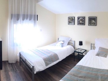 Children's room with twin beds and plenty of toys. Baby equipment available