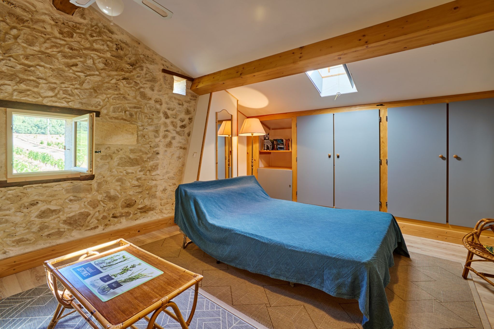 At the top of the stairs, a single bed; on the mezzanine, a single bed