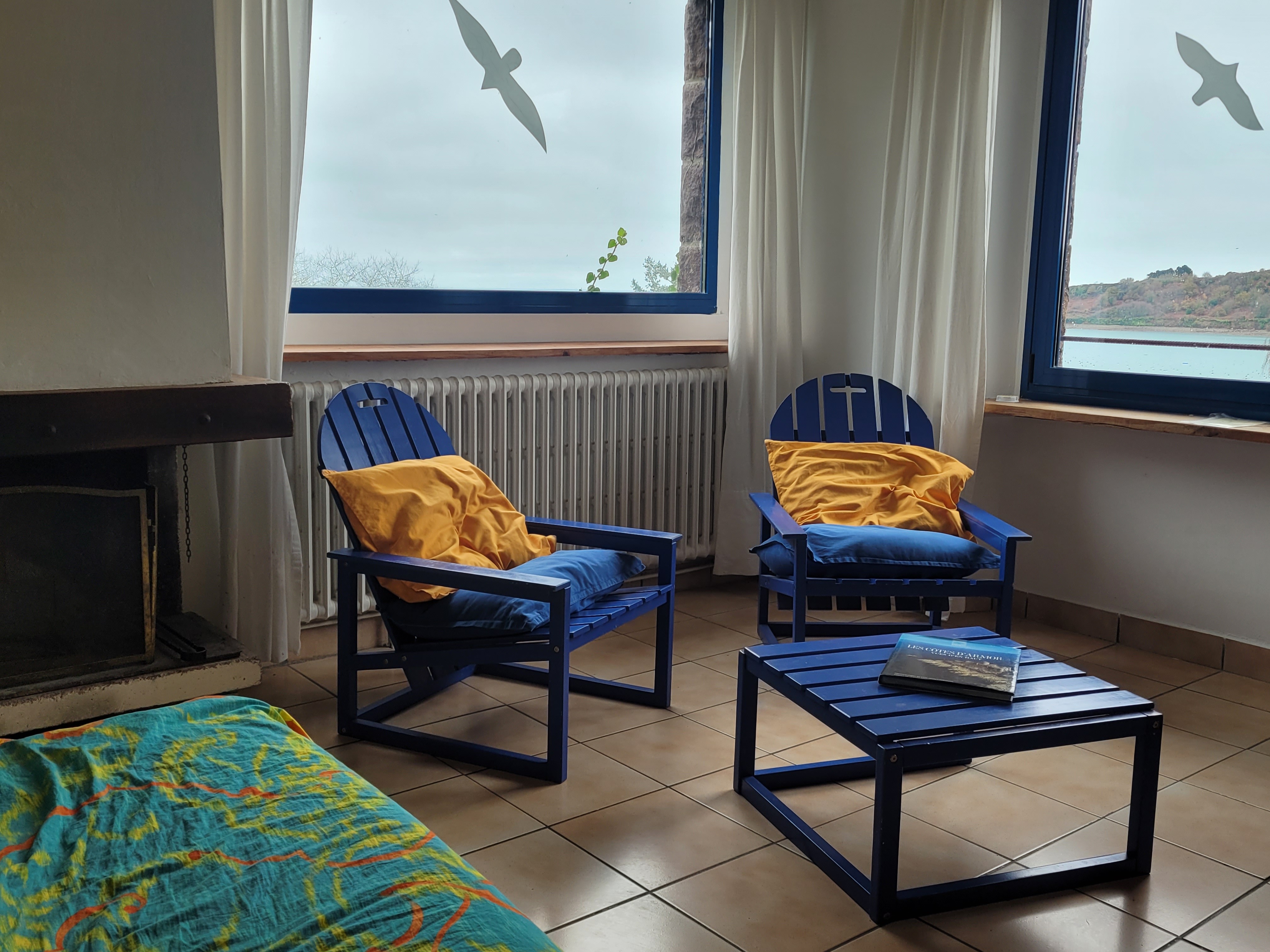 Le coin salon avec cheminée et vue imprenable  sur la baie