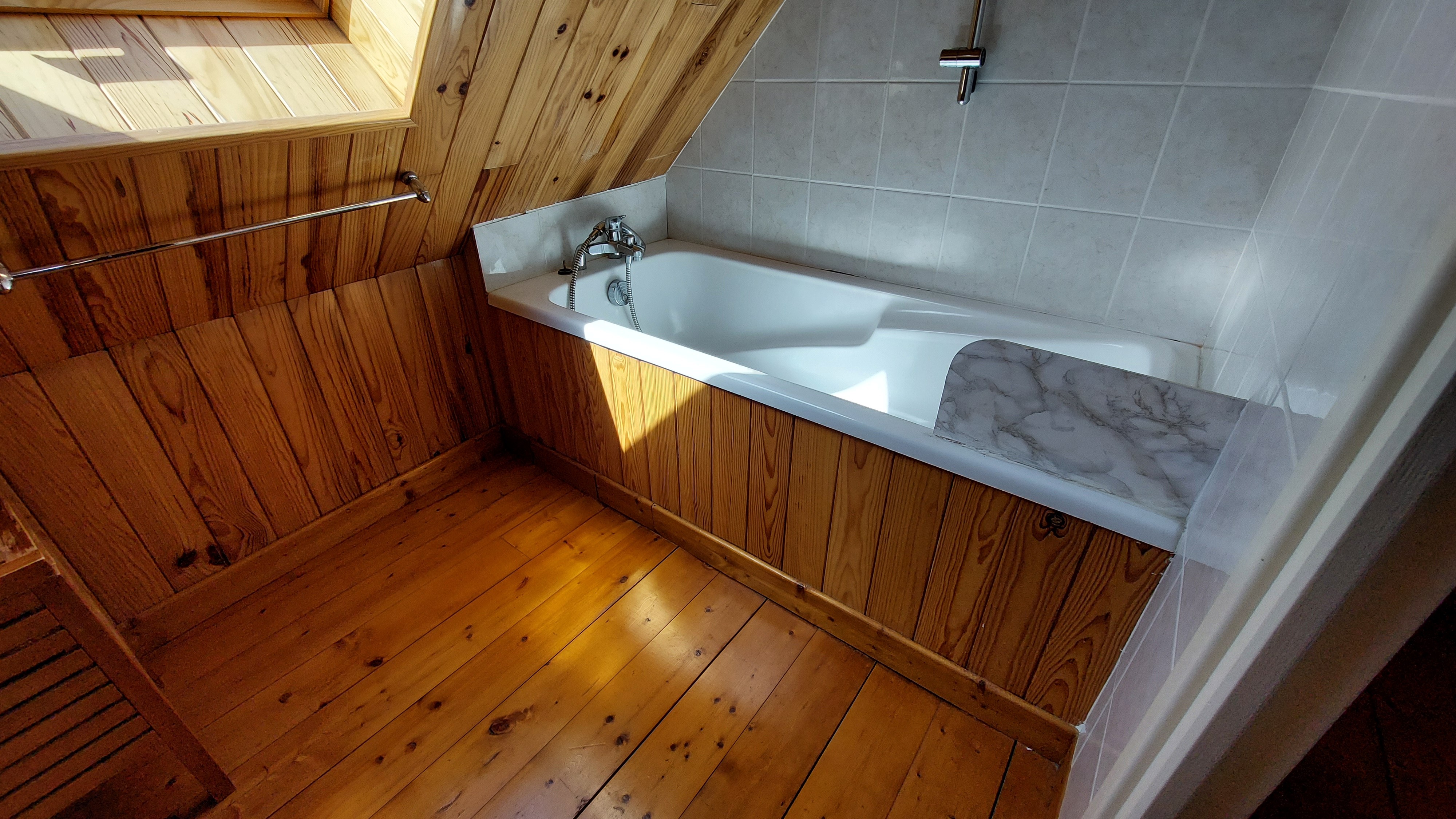 Upstairs bathroom with bathtub for relaxing moments