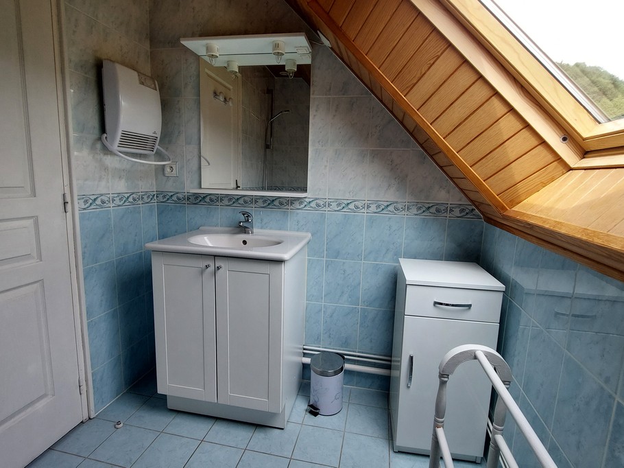Salle de bain lumineuse avec vasque et fenêtre – Gîte à Laveissière dans le Cantal