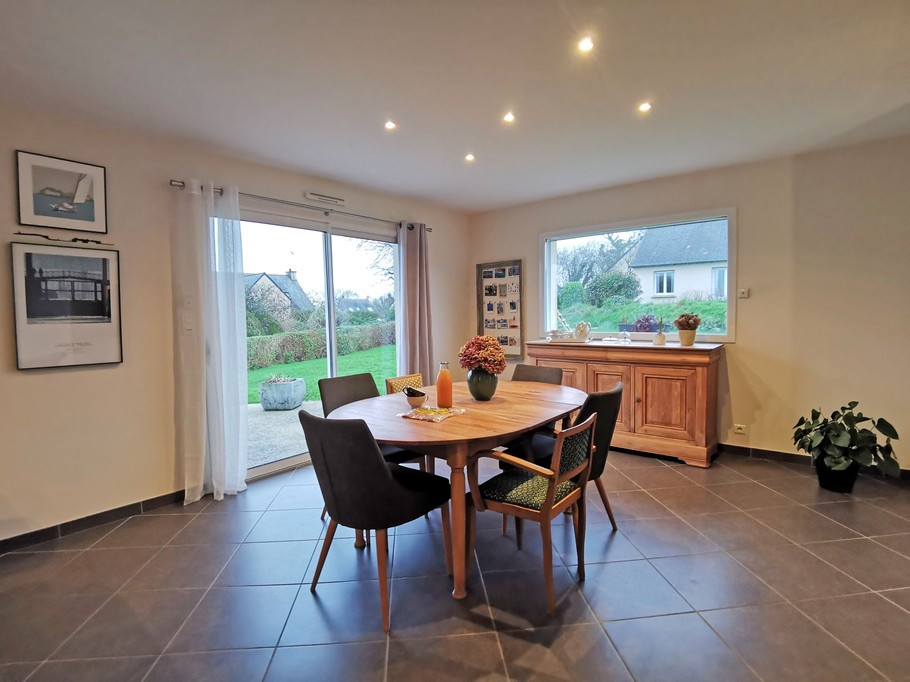 Living room with dining table leading onto terrace