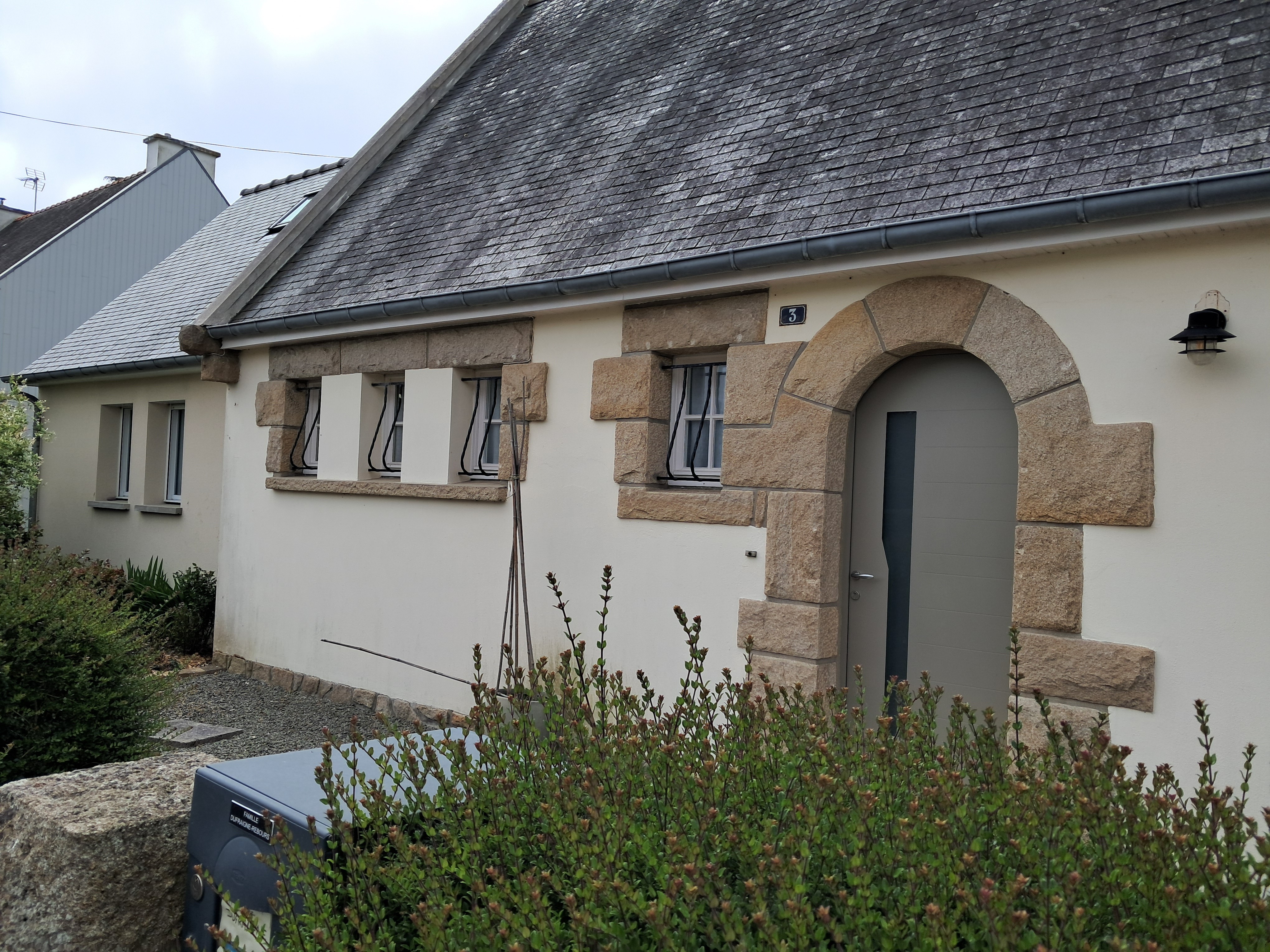 Entée de la maison avec un espace clos et paysagé