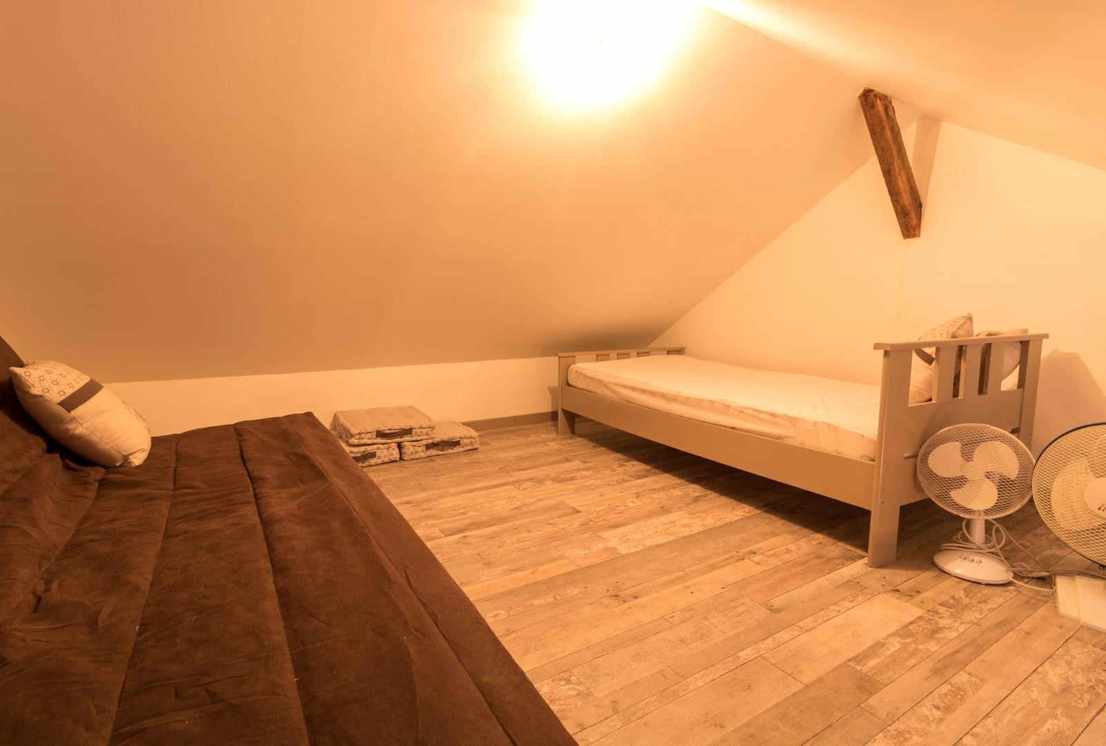 Sleeping and relaxation area on the mezzanine, accessed via a steep staircase