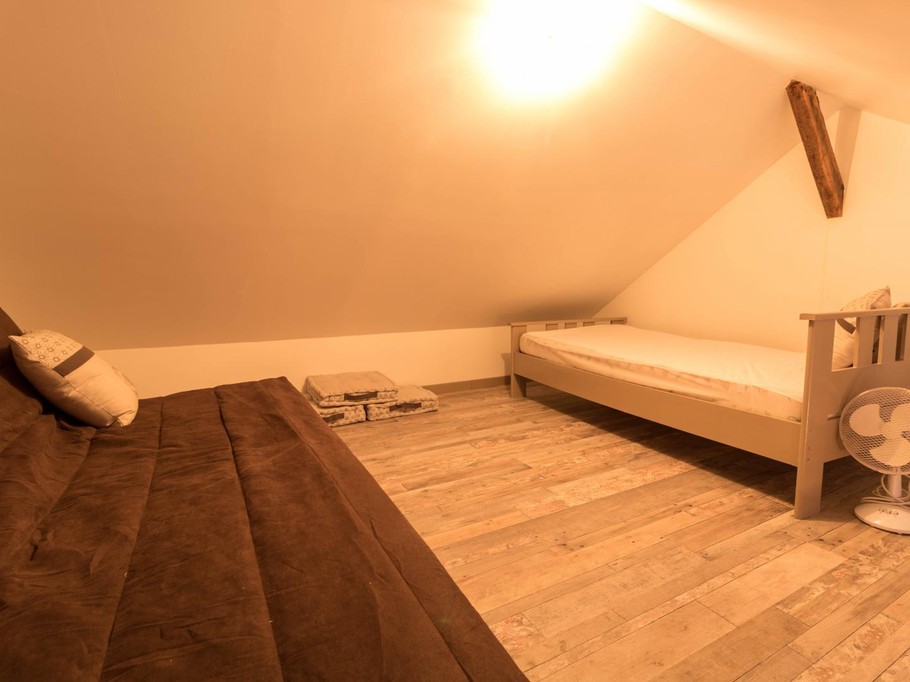 Sleeping and relaxation area on the mezzanine, accessed via a steep staircase