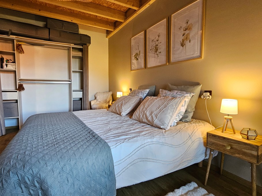 A large double bedroom with a walk-in wardrobe and a desk.