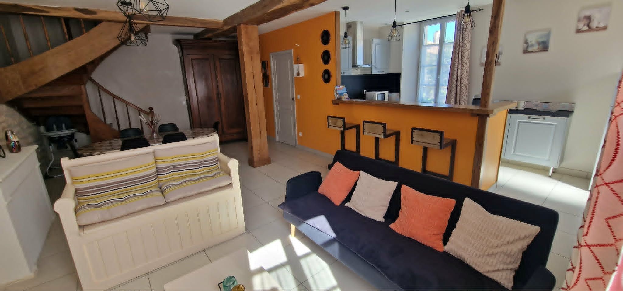 The 30 m² living room with fitted kitchen, lounge and dining area at Logis de La Passerelle in Port d'Envaux, Charente maritime.