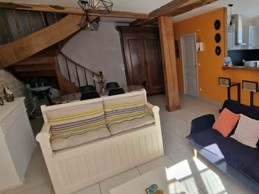 The 30 m² living room with fitted kitchen, lounge and dining area at Logis de La Passerelle in Port d'Envaux, Charente maritime.