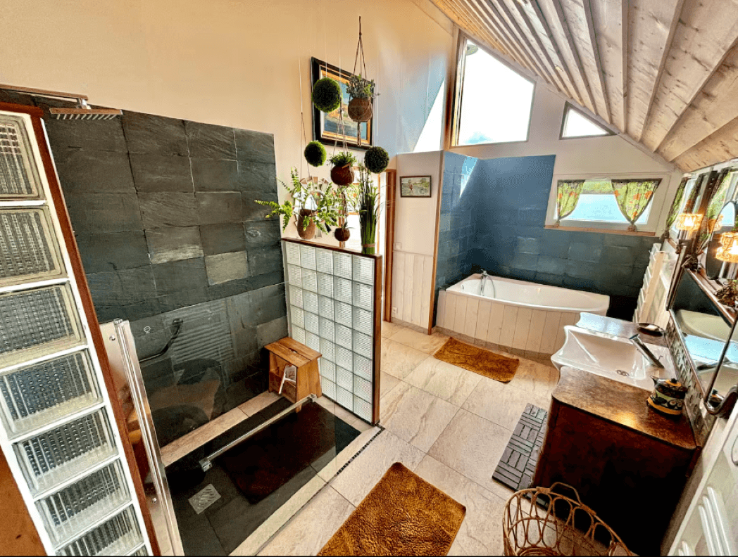 On the ground floor, a bathroom with a bath and shower