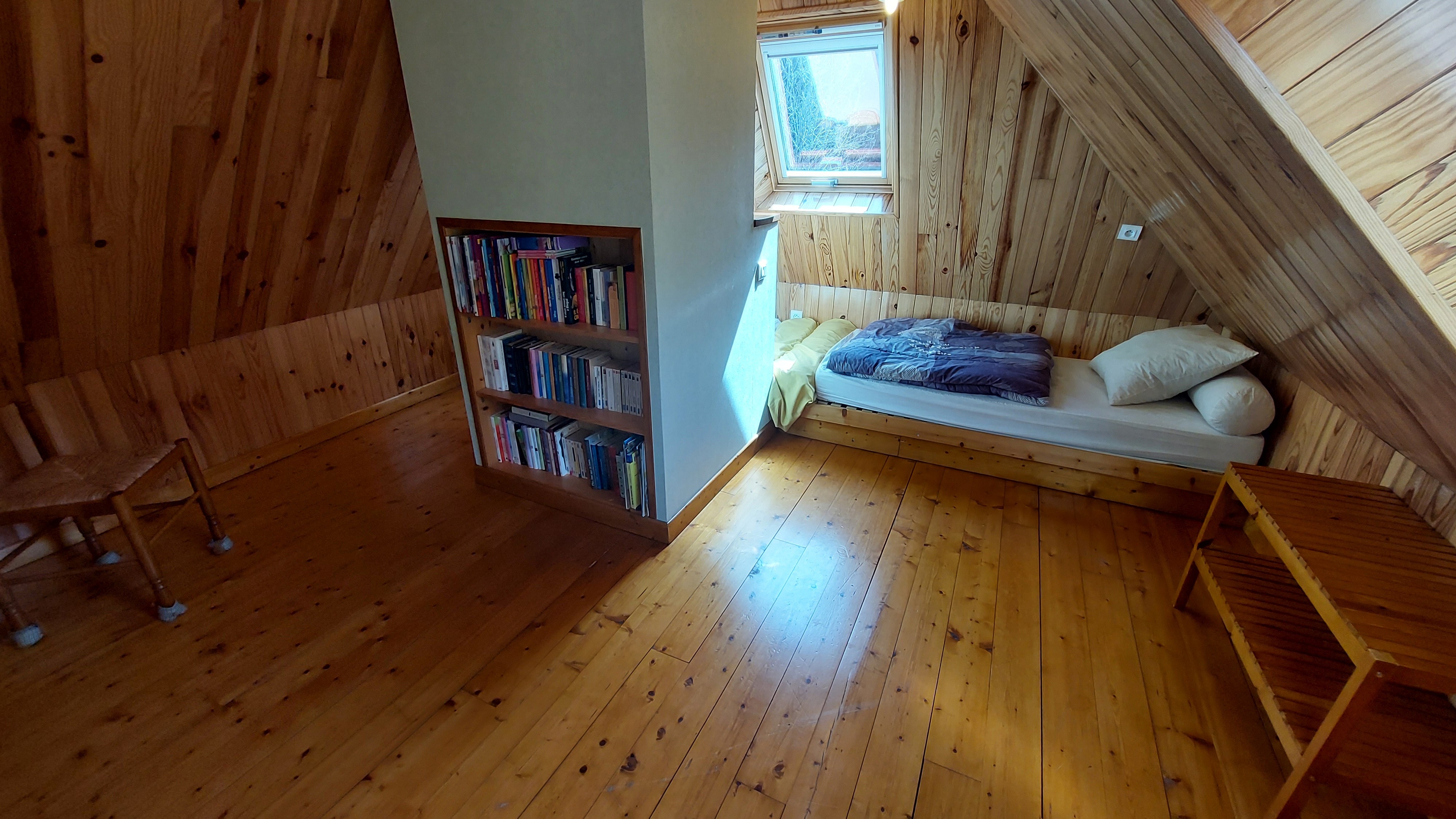Children's bedroom under the roof with several beds