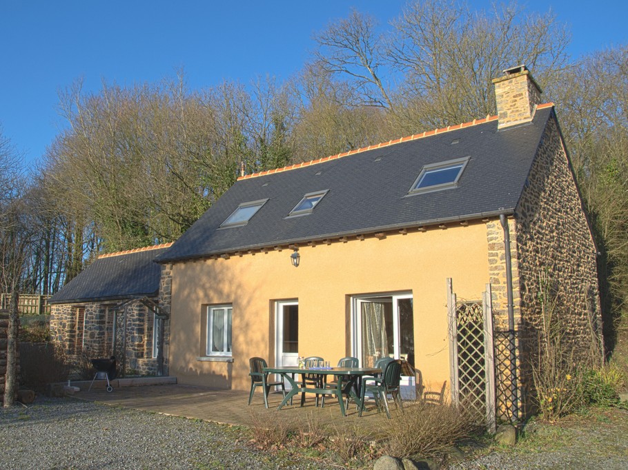 Façade de la maison avec la terrasse et la porte d'entrée.