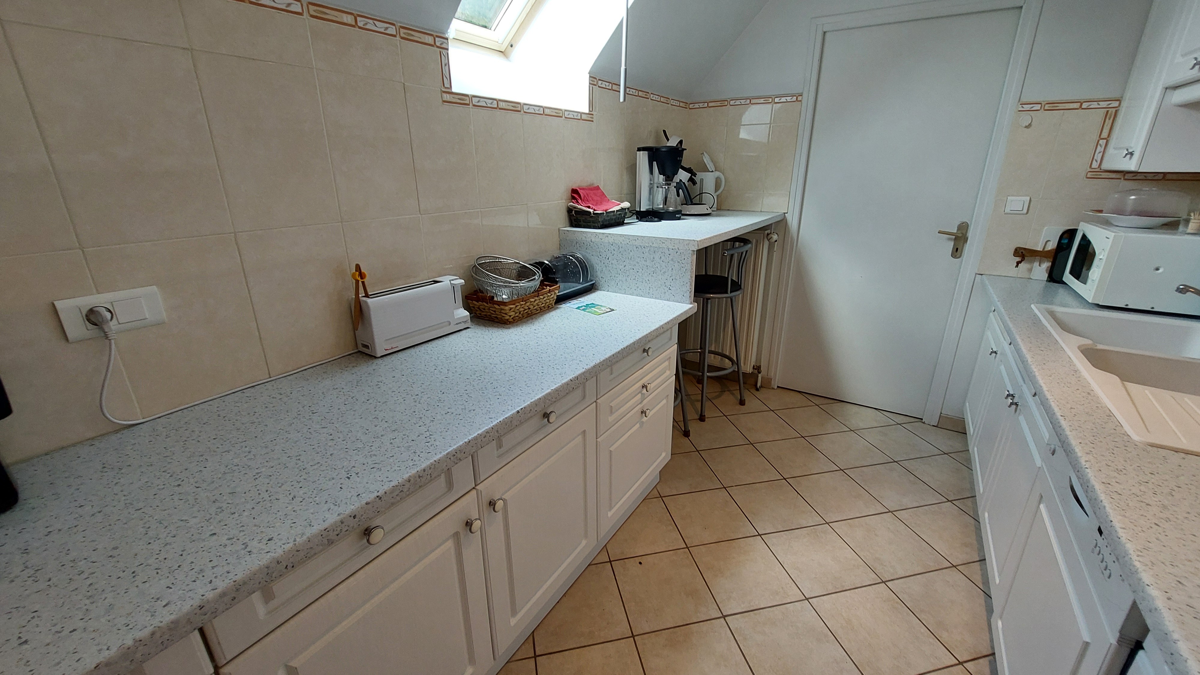 Bright kitchen with worktop and storage space in a holiday gîte in the Auvergne