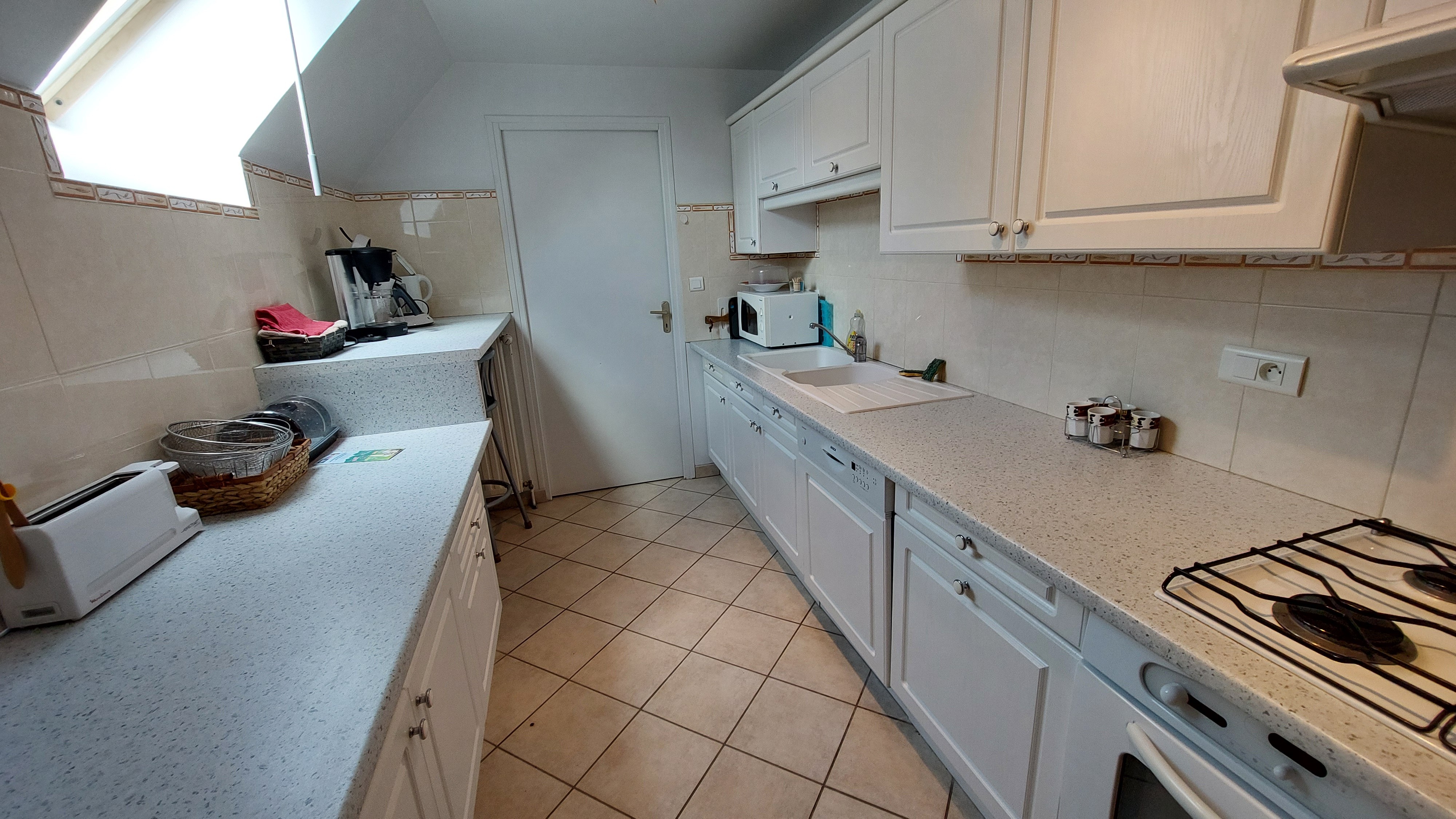 Fully equipped kitchen with appliances in the gîte at Le Claux in the Cantal