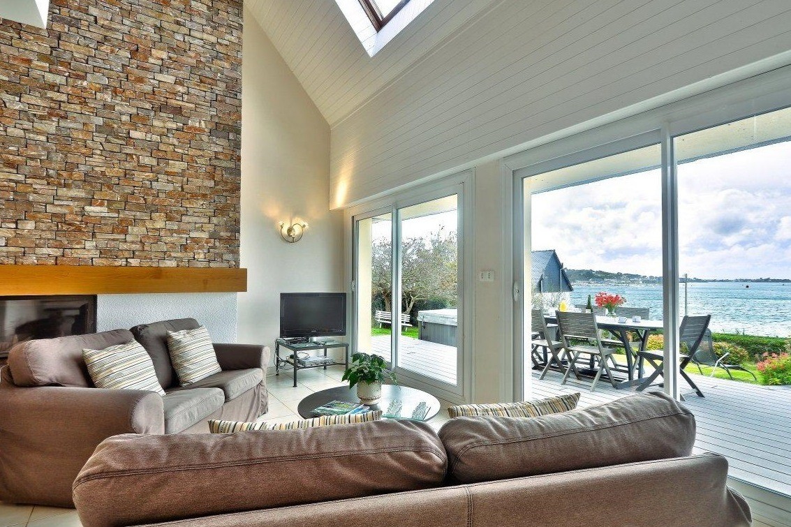 Large lounge with fireplace and full sea views