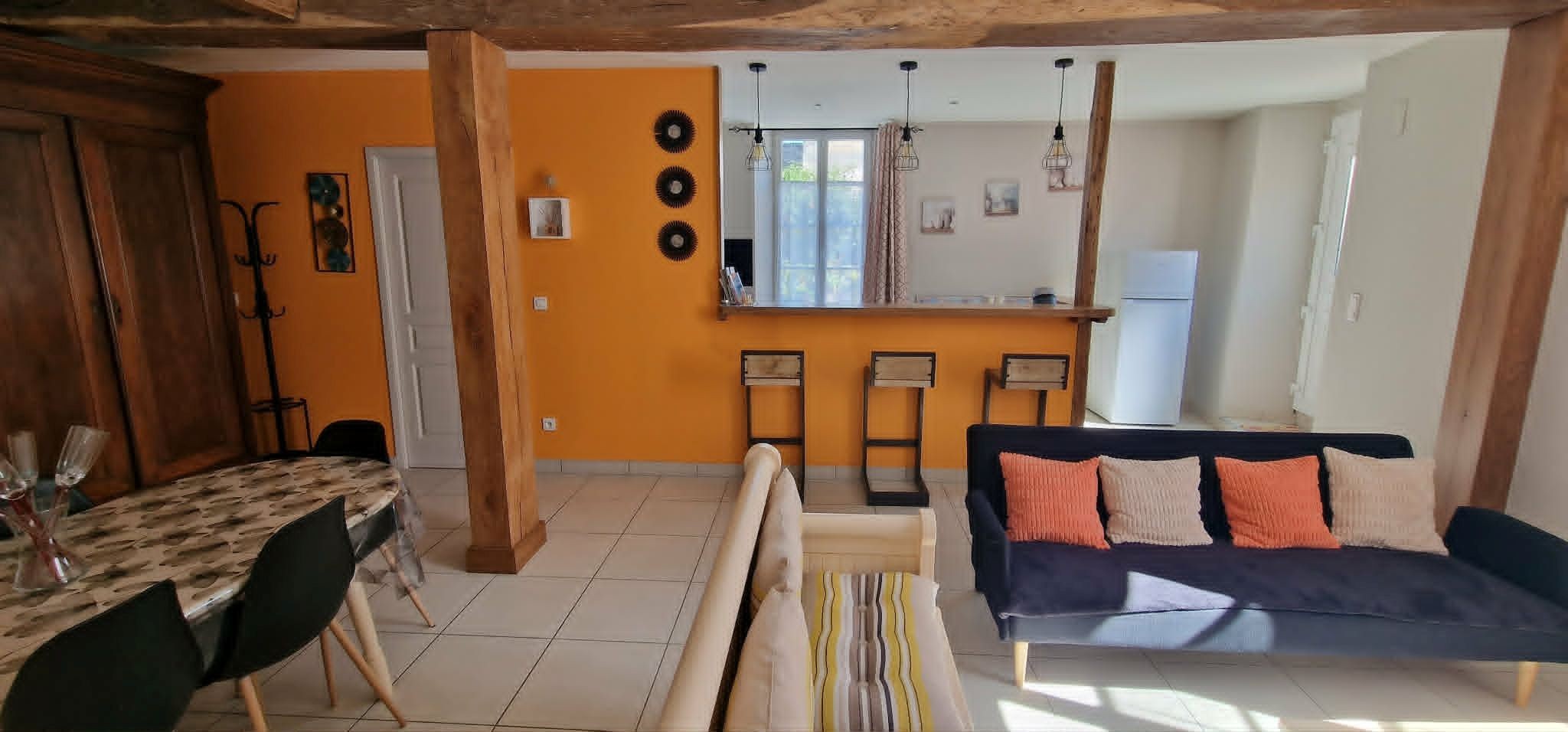 The 30 m² living room with fitted kitchen, lounge and dining area at Logis de La Passerelle in Port d'Envaux, Charente maritime.