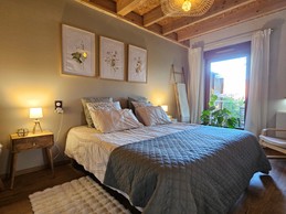 A large double bedroom with a walk-in wardrobe and a desk.
