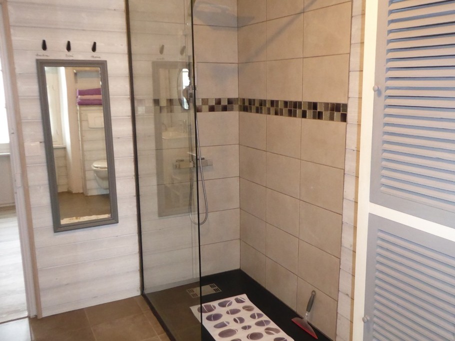Spacious shower room with walk-in shower, vanity unit and wall-hung WC.