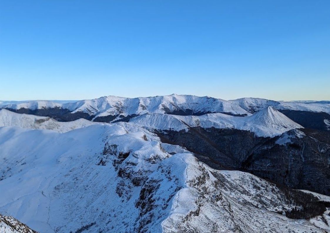 The snow-capped peaks of Puy Mary in the Cantal volcanic massif