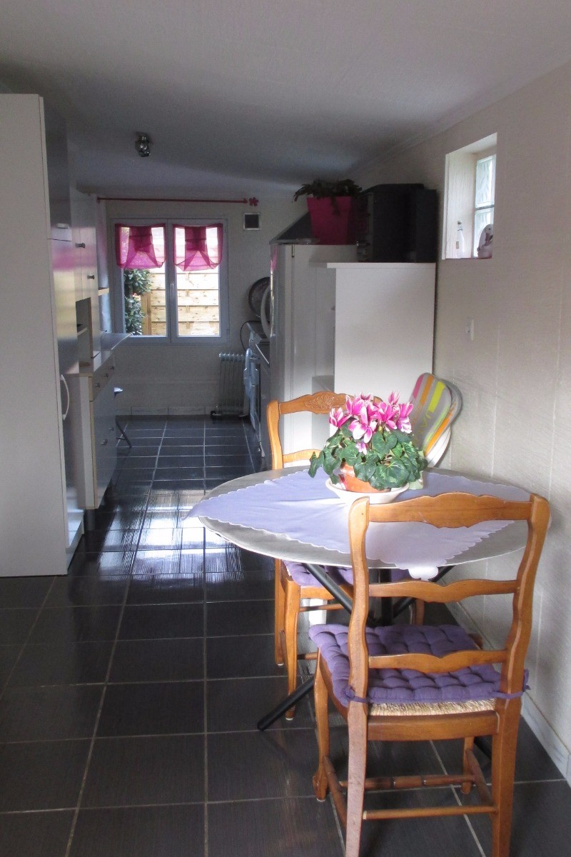 Location Trélevern, partie cuisine avec table à manger