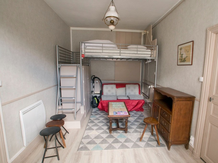 salon avec mezzanine, lit de 140 x 190, et canapé BZ également en 140 x 190, penderie et rangements sous l'escalier de la mezzanine