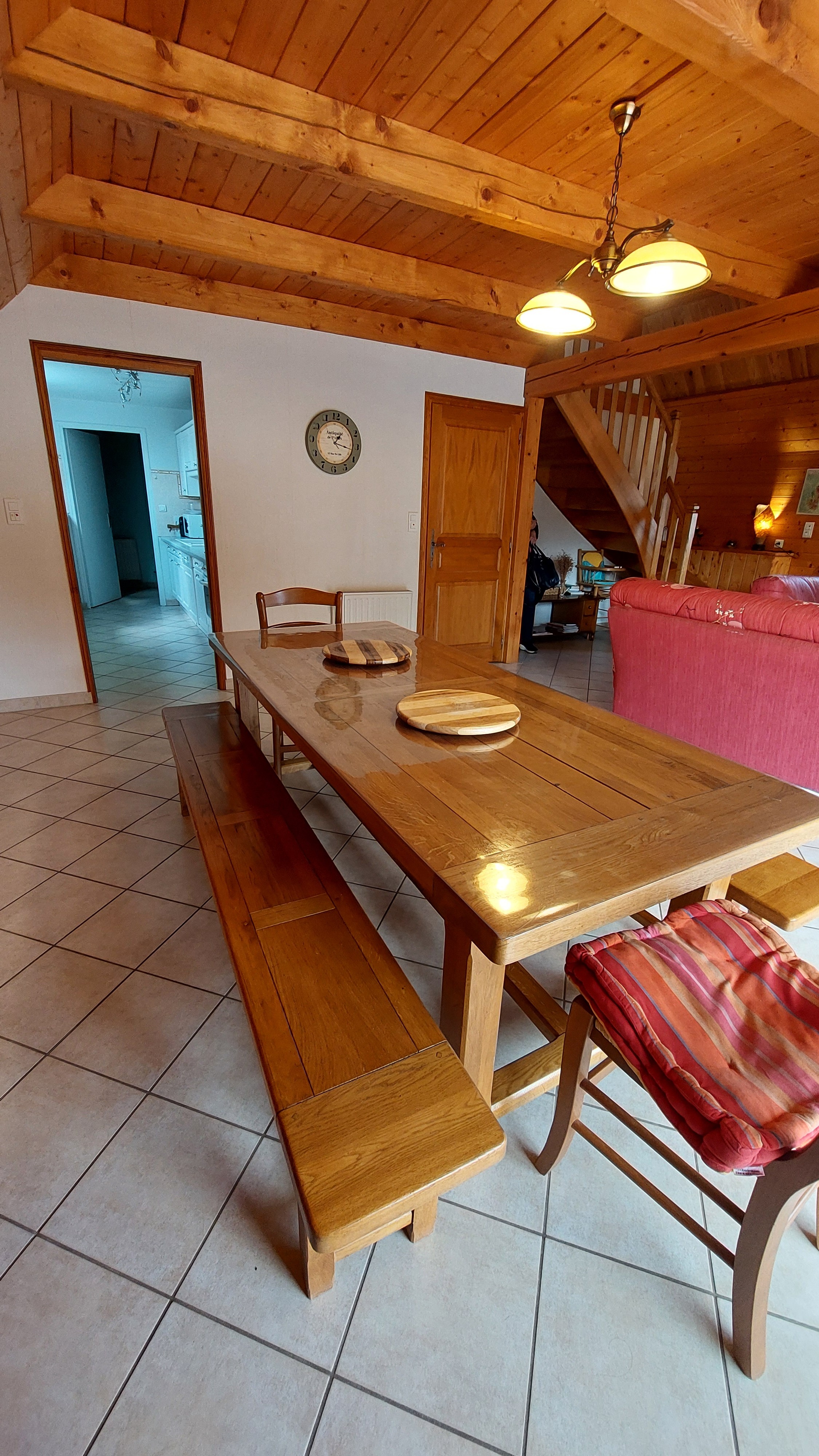 Bright dining room with kitchen access and staircase in character gîte in Le Claux